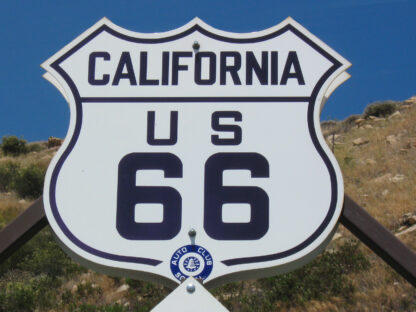 A California US Route 66 sign installed on a brown metal pole.