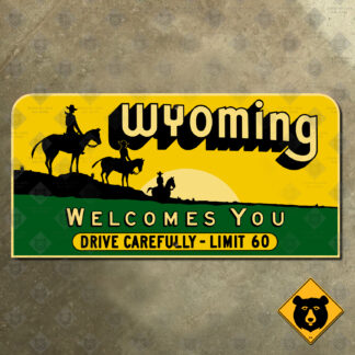 Wyoming Welcomes You with cowboys state line sign